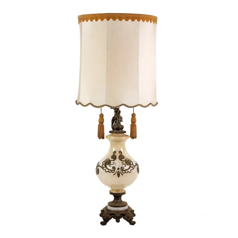 CARL FALKENSTEIN STYLE MONUMENTAL GLASS TABLE LAMP: Carl Falkenstein style monumental glass table lamp with scrolling bronze base, resin floral motif embellishments, silk shade with suede trim, and bronze cherub figure near the neck of the lamp.