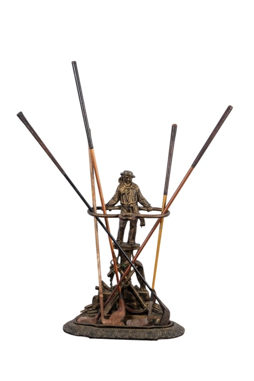 VINTAGE UMBRELLA STAND & 5 CLUBS: Vintage umbrella stand & 5 clubs. Approximate dimensions: stand h. 29", w. 21", d. 10" Disclaimer: Participating bidders must have a credit card on file with LiveAuctioneers in order for their