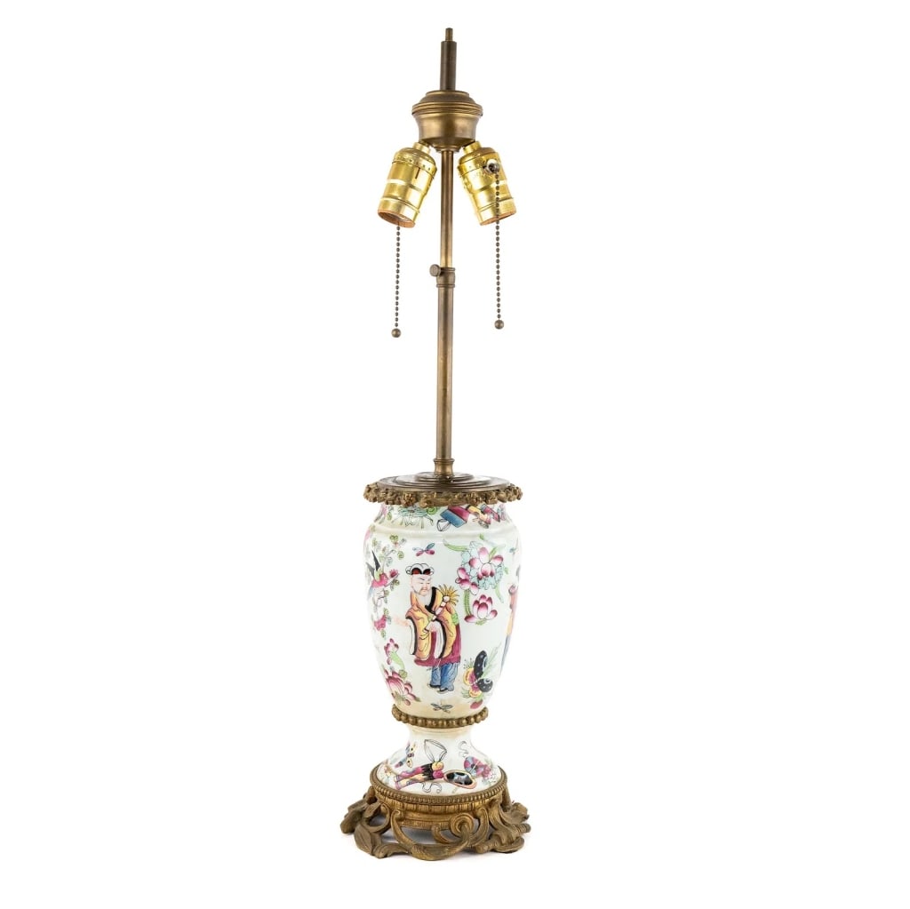 FAMILLE ROSE PORCELAIN & ORMOLU TABLE LAMP: Famille Rose porcelain and ormolu table lamp with hand-painted motifs of people amongst a flower garden. Approximate dimensions: h. 25", dia. 6" Disclaimer: Participating bidders must have a credit ca