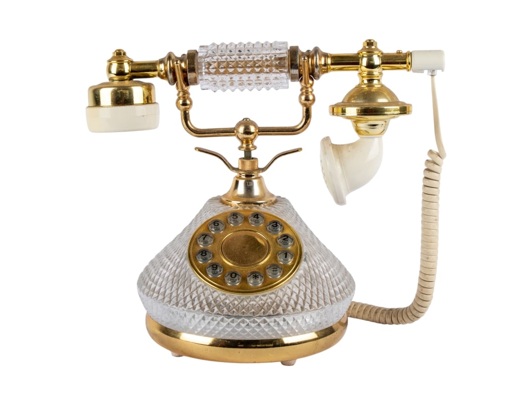 HOLLYWOOD REGENCY GLASS ROTARY TELEPHONE: Hollywood Regency glass rotary telephone. Approximate dimensions: h. 9", w. 5", d. 10" Disclaimer: Participating bidders must have a credit card on file with LiveAuctioneers in order for their