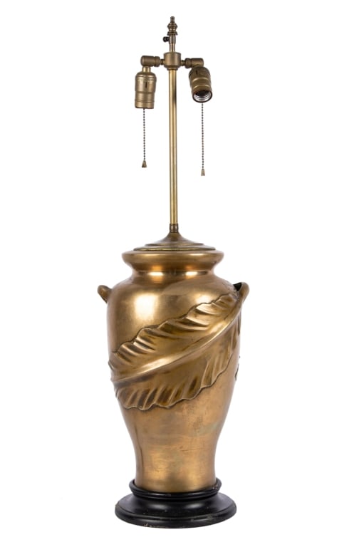 ART NOUVEAU STYLE BRASS TABLE LAMP: Art Nouveau style brass table lamp with double bulb and leaf motif. Approximate dimensions: h. 31", dia. 8.5" Disclaimer: Participating bidders must have a credit card on file with LiveAuctioneers in 