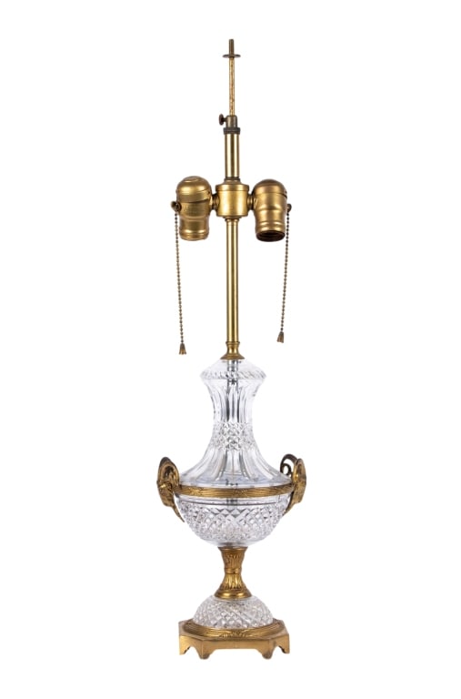 NEOCLASSICAL GLASS & BRASS RAM HEAD TABLE LAMP: Neoclassical glass and brass ram head table lamp. Approximate dimensions: h. 25", w. 6", d. 5" Disclaimer: Participating bidders must have a credit card on file with LiveAuctioneers in order for