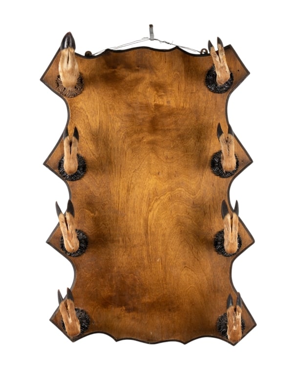 DEER HOOF GUN RACK: Deer hoof gun rack with 8 hoofs. Approximate dimensions: h. 32", w. 22", d. 6" Disclaimer: Participating bidders must have a credit card on file with LiveAuctioneers in order for their bidding