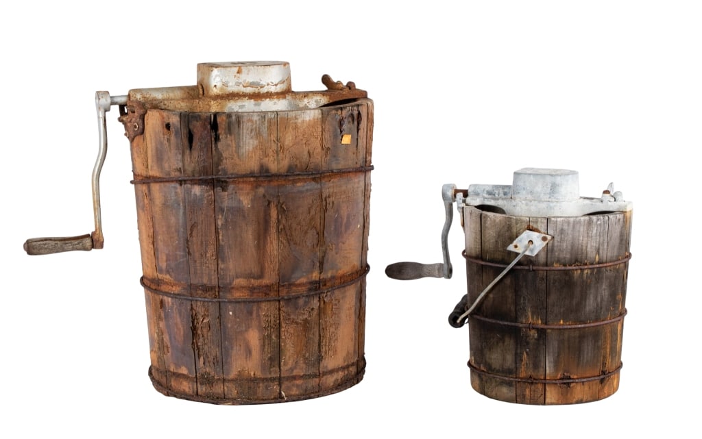 TWO ANTIQUE HAND CRANK ICE CREAM MAKERS: Two antique hand crank ice cream makers. Approximate dimensions: h. 18", dia. 20" Disclaimer: Participating bidders must have a credit card on file with LiveAuctioneers in order for their bidding regi