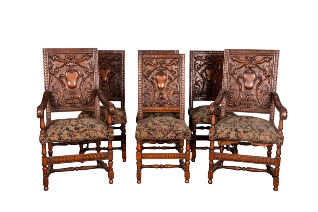 SET OF 6 FRENCH RENAISSANCE REVIVAL DINING CHAIRS: Set of 6 French Renaissance Revival dining chairs with inset carved panels, stretcher base, nailtrim accents, and intricately carved arms. Approximate dimensions: armchair - h. 45", w. 24", d. 23"