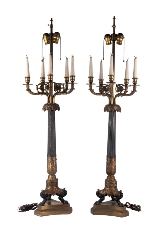 PAIR OF FRENCH EMPIRE CANDLESTICK TABLE LAMPS: Pair of French Empire candlestick table lamps. Approximate dimensions: h. 44", w. 14" Disclaimer: Participating bidders must have a credit card on file with LiveAuctioneers in order for their bidding