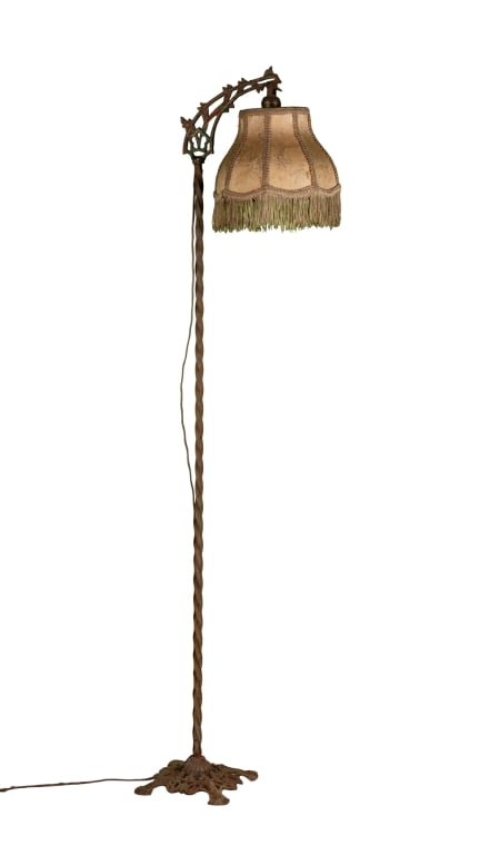 ART DECO FLOOR LAMP: Art Deco floor lamp with botanical accent and fringe shade. Approximate dimensions: h. 57", w. 12", d. 9" Disclaimer: Participating bidders must have a credit card on file with LiveAuctioneers in