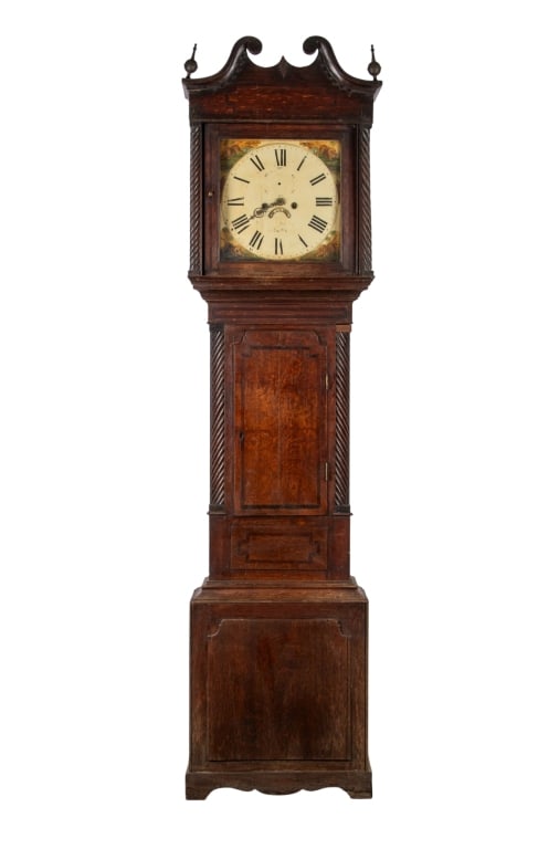 19TH CENTURY ENGLISH GRANDFATHER CLOCK: 19th century English grandfather clock with carved finials, broken arch, and twisted posts. Approximate dimensions: h. 95.5", w. 21", d. 10" Disclaimer: Participating bidders must have a credit card
