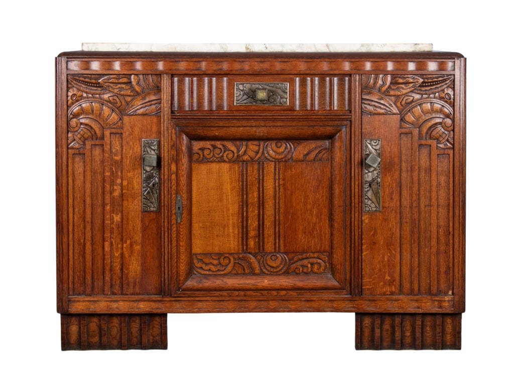 ART DECO STYLE MARBLE TOP BUFFET: Art Deco style marble top buffet with inset carved panels, metal square pulls, and carved metal panels. Approximate dimensions: h. 43.25", w. 57", d. 18" Disclaimer: Participating bidders must have a 