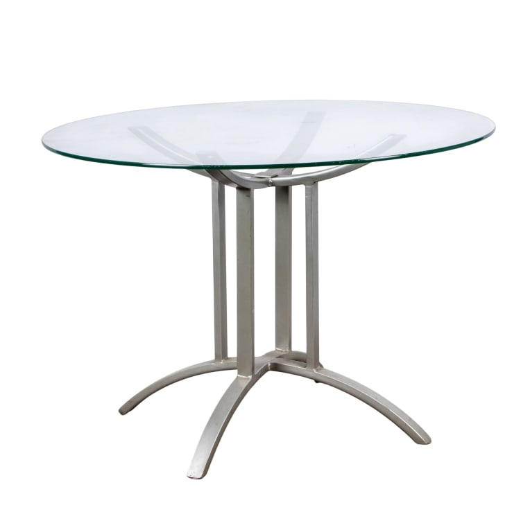 MODERN GLASS & METAL BREAKFAST TABLE: Modern glass and metal breakfast table. Approximate dimensions: h. 29", dia. 42" Disclaimer: Participating bidders must have a credit card on file with LiveAuctioneers in order for their bidding regis