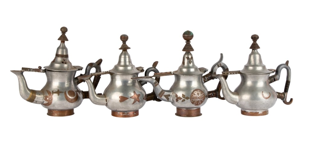 FIVE AFRICAN TUAREG PEWTER TEAPOTS: Five African Tuareg pewter teapots. Approximate dimensions: h. 7", w. 8", d. 4" Disclaimer: Participating bidders must have a credit card on file with LiveAuctioneers in order for their bidding