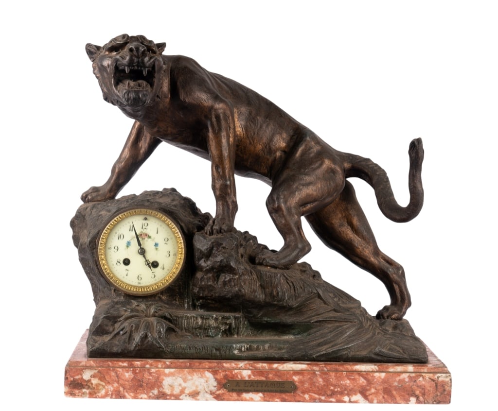 A L'ATTAQUE CAST METAL CLOCK: A L'Attaque cast metal clock with panther figure. Approximate dimensions: h. 18", w. 19.5", d. 9.5" Disclaimer: Participating bidders must have a credit card on file with LiveAuctioneers in order for