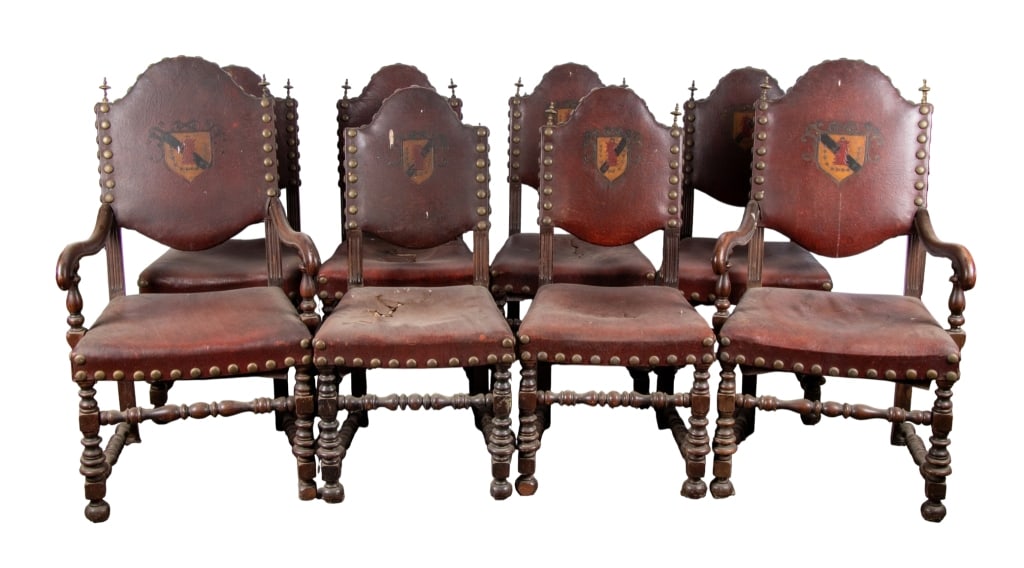 SET OF 8 RENAISSANCE REVIVAL DINING CHAIRS: Set of 8 Renaissance Revival dining chairs in red leather with painted crest and jumbo nailhead, including 2 armchairs and 6 side chairs. Approximate dimensions: h. 45", w. 25", d. 24" Disclaimer: Par
