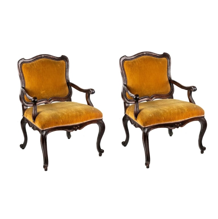 PAIR OF 18TH C. ITALIAN ROCOCO CHAIRS: pair of 18th C Italian Rococo fauteuil armchairs both having carved wood scrolling arms, carved scrolling motif trim, and goldenrod upholstered seats and backs Approximate dimensions: h. 38.5", w. 27"