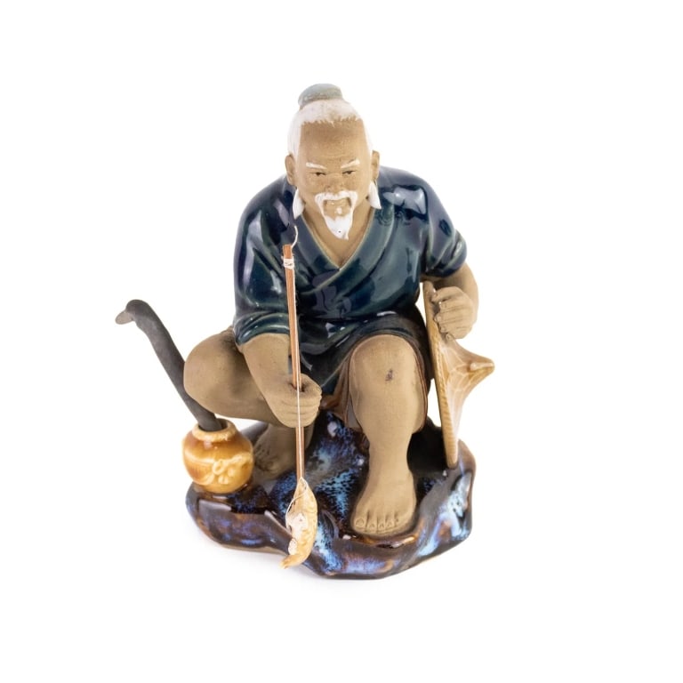 CHINESE FISHERMAN MUDMAN FIGURE: Chinese mudman figurine depicting an older fisherman with a recent catch at the end of his line. Stamped 'China' on underside. Approximate dimensions: h. 9.5", w. 5.5", d. 4" Disclaimer: