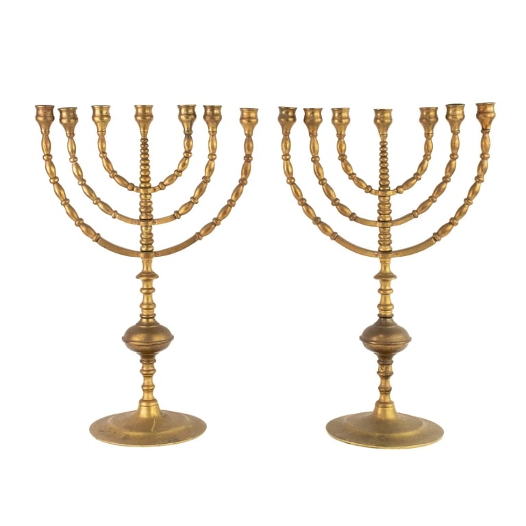 PAIR OF BRASS SEVEN LIGHT MENORAHS: pair of Jewish brass seven light menorahs, having beaded arms and bulbous stems. Approximate dimensions: h. 18", w. 12", d. 6.5" Disclaimer: Participating bidders must have a credit card on file with
