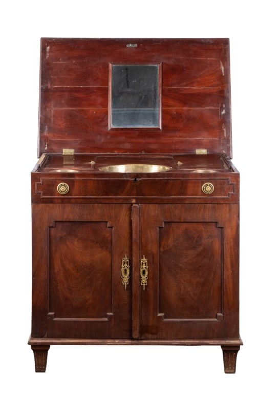 VICTORIAN MAHOGANY LIFT TOP WASHSTAND: Victorian mahogany lift top washstand with mirror and three buckets, inset carved panels, and floral motif brass pulls. Approximate dimensions: h. 32.25", w. 35", d. 22" Disclaimer: Participating bidd