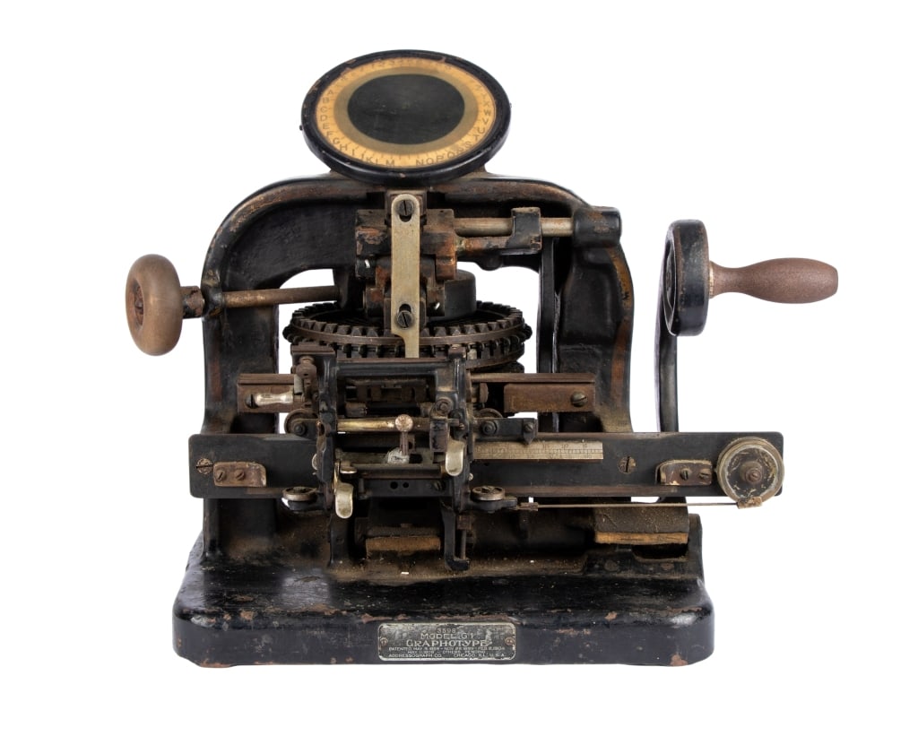 20TH C. GRAPHOTYPE DOG TAG MACHINE: 20th century graphotype dog tag machine. Approximate dimensions: h. 16", w. 20", d. 14" Disclaimer: Participating bidders must have a credit card on file with LiveAuctioneers in order for their biddin