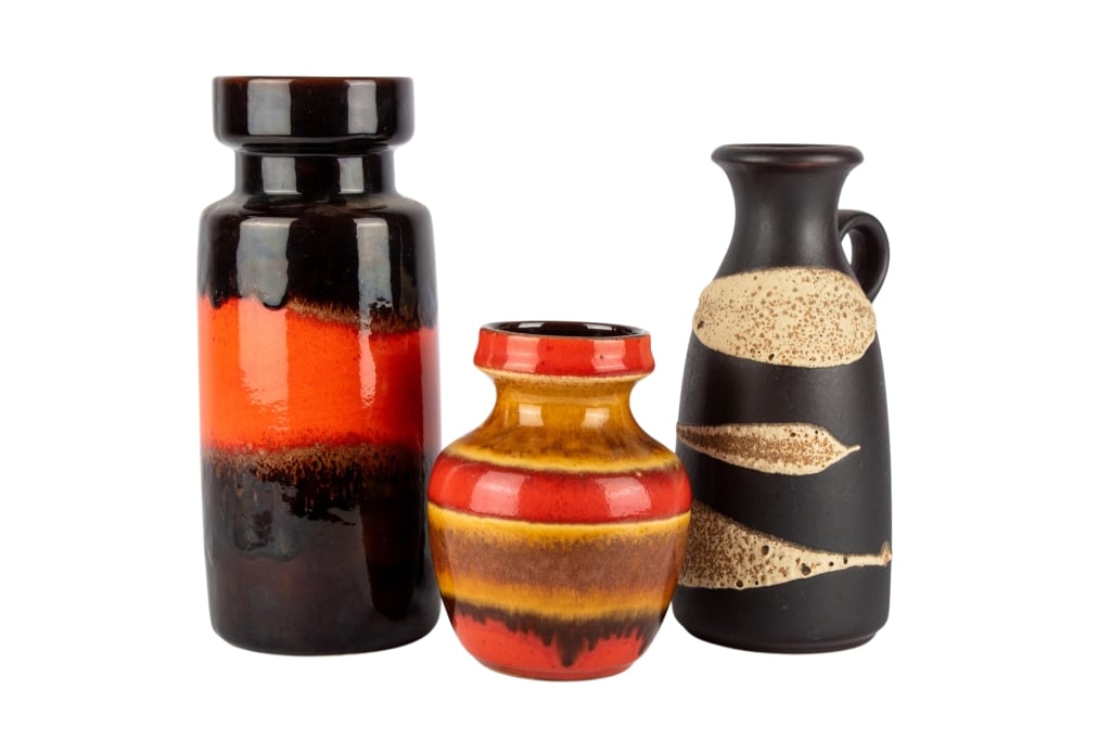 GROUP OF THREE MCM WEST GERMAN POTTERY ITEMS: Group of three MCM West German pottery items. Marked to bottom. Approximate dimensions: h. 12", w. 5", d. 5" Disclaimer: Participating bidders must have a credit card on file with LiveAuctioneers in