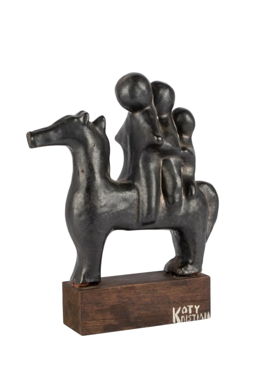 MCM KOTY KRISTIAN HORSE SCULPTURE: MCM Koty Kristian horse sculpture with three figures on horseback mounted to wood base, signed. Approximate dimensions: h. 11", w. 9", d. 4" Disclaimer: Participating bidders must have a credit card