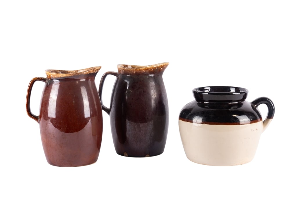 TWO HULL POTTERY PITCHERS & 1 UNMARKED PIECE: Two Hull pottery pitchers & 1 unmarked piece. Approximate dimensions: largest h. 9", w. 7", d. 5" Disclaimer: Participating bidders must have a credit card on file with LiveAuctioneers in order for
