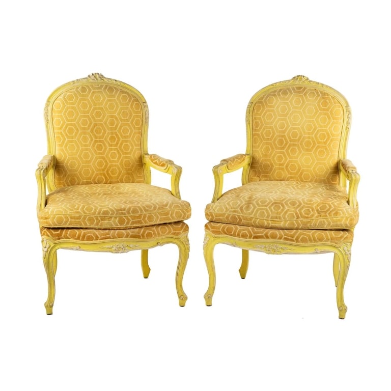 PAIR OF LOUIS XV STYLE BERGERE CHAIRS: Pair of Louis XV style bergere armchairs having golden yellow fabric upholstery with geometric shape pattern and yellow painted wood frames adorned with carved floral designs. Unmarked. Approximate