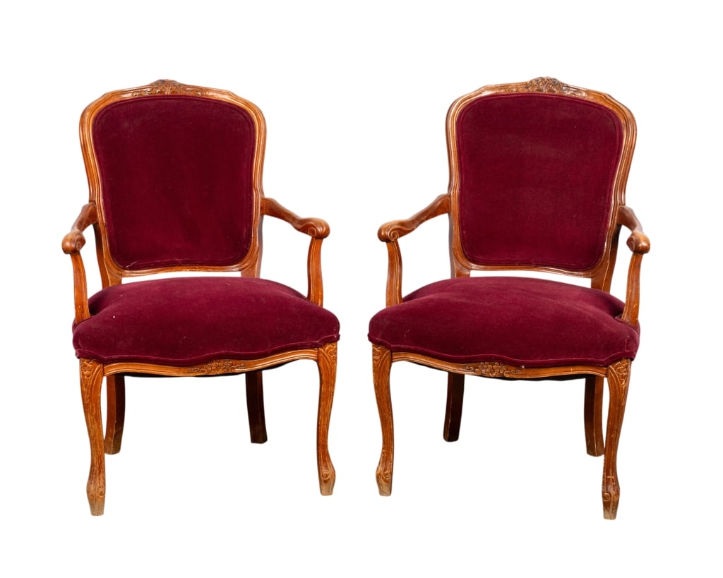 PAIR OF LOUIS XV STYLE ARMCHAIRS: Pair of Louis XV Style armchairs with carved floral accents, maroon velvet upholstery, and cabriole legs. Approximate dimensions: h. 34", w. 22", d. 18" Disclaimer: Participating bidders must have a