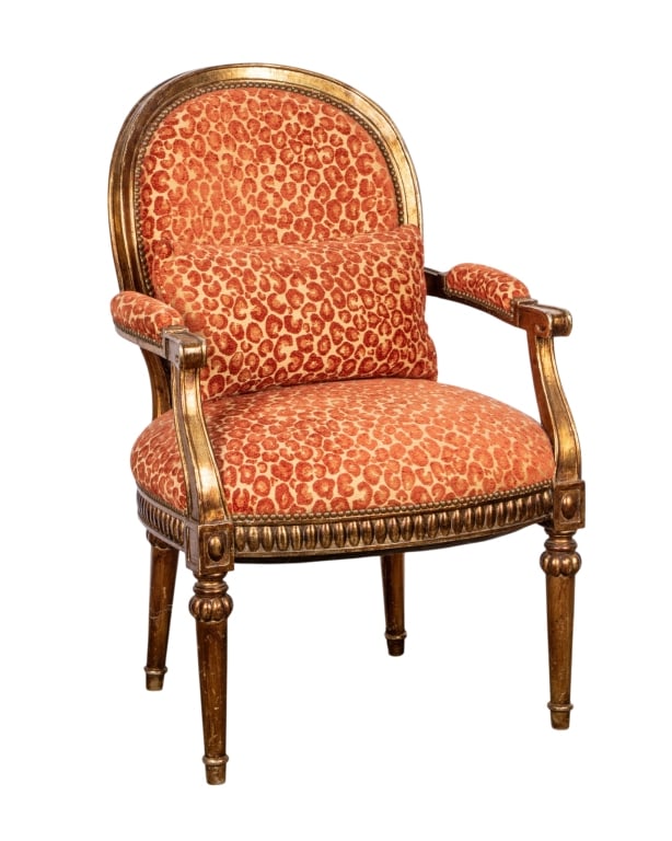 LOUIS XVI STYLE ANIMAL PRINT ARMCHAIR: Louis XVI style animal print armchair with fluted legs, set back arms with padded armrests and carved motifs. Approximate dimensions: h. 40", w. 26", d. 19" Disclaimer: Participating bidders must