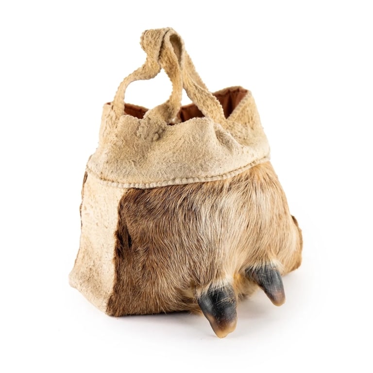 NATIVE AMERICAN DEER HOOF BAG: Native American deer skin bag possibly Lakota or Sioux featuring deer hoof decorations near the bottom. Approximate dimensions: h. 7", w. 9", d. 8" Disclaimer: Participating bidders must have a