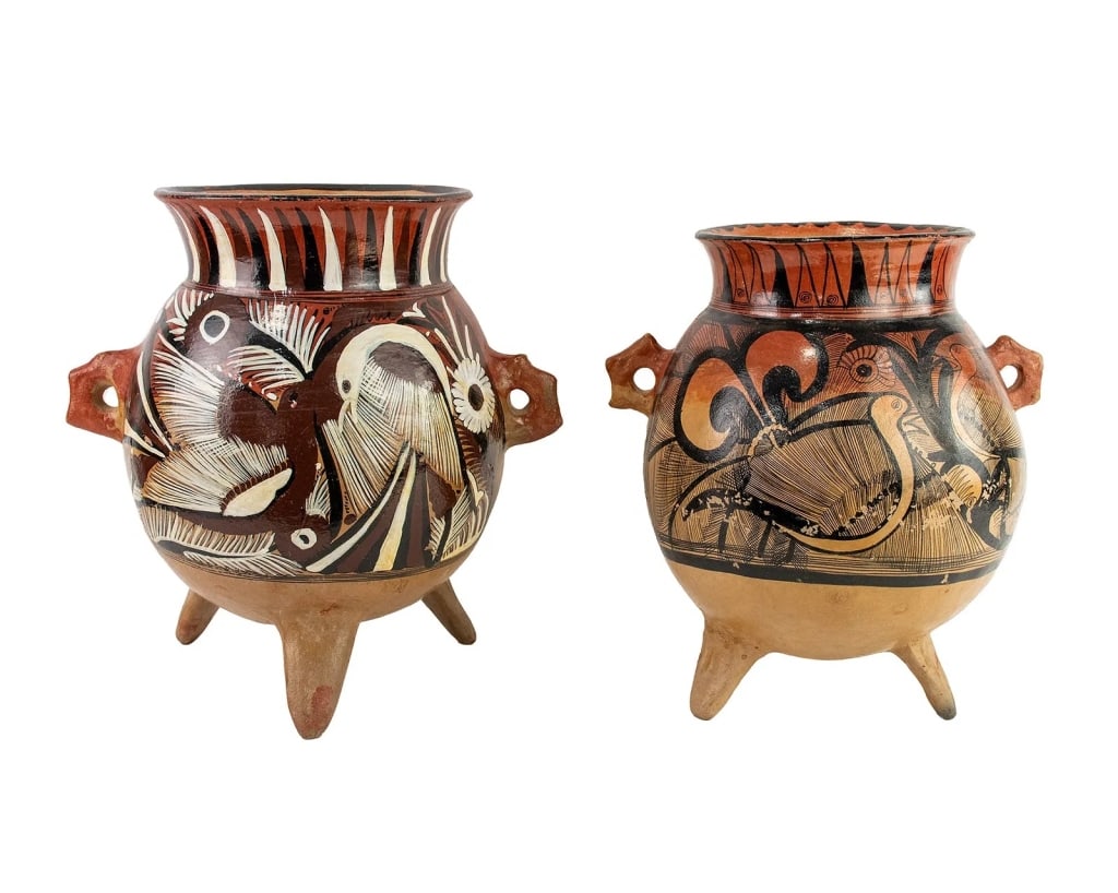 PAIR OF MEXICAN TONALA TERRACOTTA POTTERY VESSELS: Pair of Mexican Tonala folk art footed terracotta pottery vessels or vases each featuring hand-painted depictions of birds and floral motifs. Approximate dimensions: h. 14.75, w. 14", d. 11" Disclaime