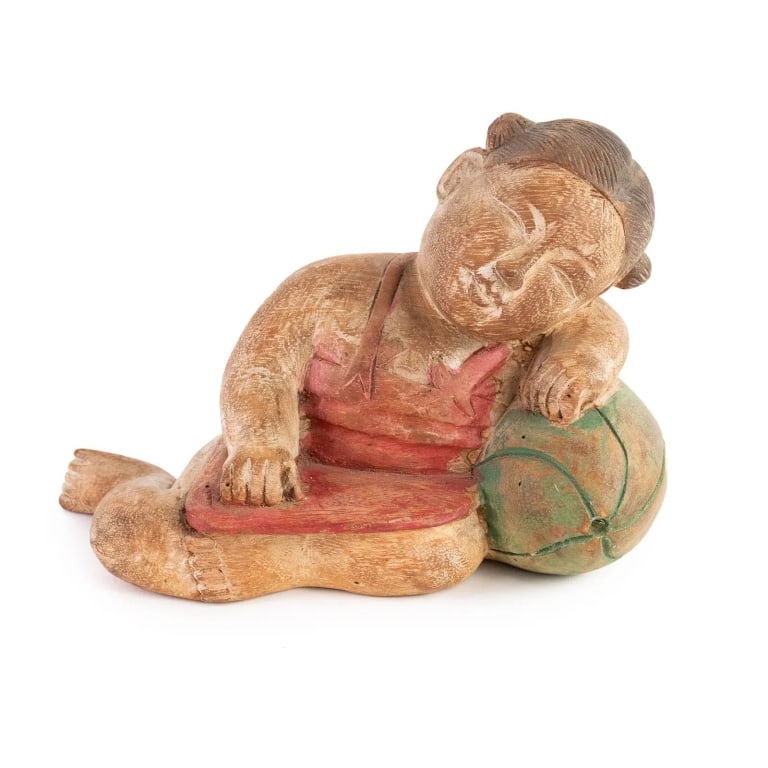 CHINESE HAND CARVED WOOD SLEEPING CHILD FIGURE: Chinese hand-carved wooden figure depicting a sleeping child leaning against what appears to be a watermelon. Unmarked. Approximate dimensions: h. 6", w. 8", d. 3.5" Disclaimer: Participating bidders