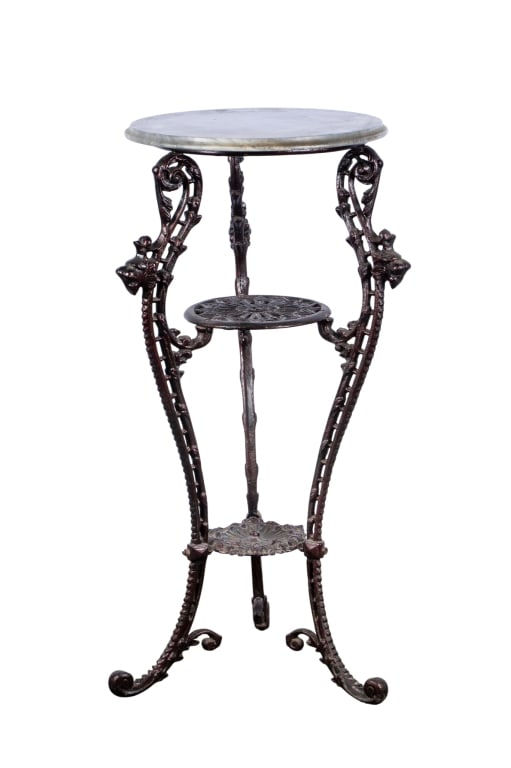 VICTORIAN STYLE IRON & MARBLE SIDE TABLE: Victorian style iron & marble side table with lion heads and floral details. Approximate dimensions: h. 39", dia. 17.5" Disclaimer: Participating bidders must have a credit card on file with