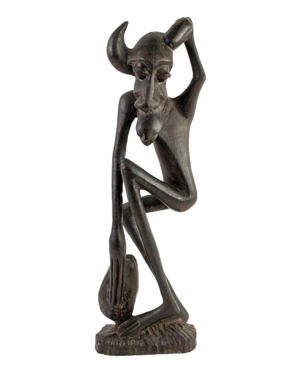 AFRICAN MAKONDE CARVED IRONWOOD SHETANI SCULPTURE: African Tanzania Makonde 'Shetani' (evil spirit or devil) carved wood figural sculpture depicting a man with extremely exaggerated features and a pair of horns atop his head. Approximate dimensions: