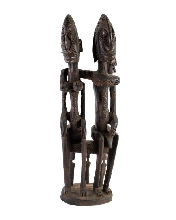 AFRICAN MALI DOGON FUNERAL SEATED COUPLE SCULPTURE: African Mali Dogon Seated Couple Funeral Sculpture (19th Century) depicting a man and woman sitting embracing each other. Woman and man having similar facial features with geometric scarification