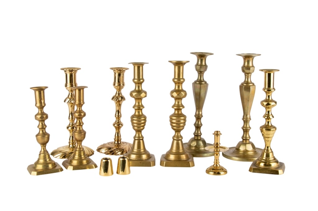 ASSORTED 12 BRASS CANDLESTICKS: Assorted 12 brass candlesticks including pairs and singles. Approximate dimensions: h. 10.5", w. 5", d. 5" Disclaimer: Participating bidders must have a credit card on file with LiveAuctioneers in
