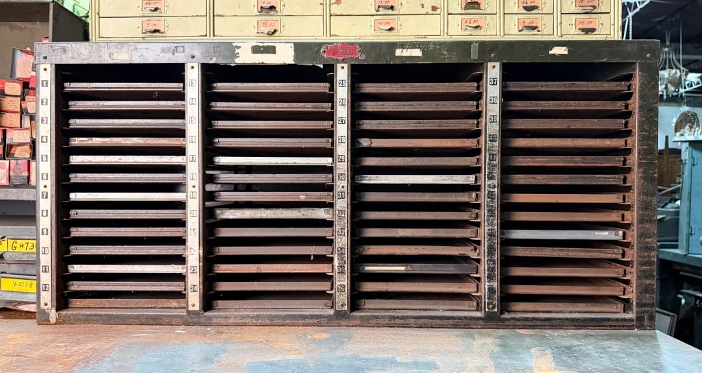 FOSTER TYPESETTER’S METAL CABINET: Foster typesetter’s metal cabinet. Approximate dimensions: h. 20", w. 43.75", d. 14.25" Disclaimer: Participating bidders must have a credit card on file with LiveAuctioneers in order for their
