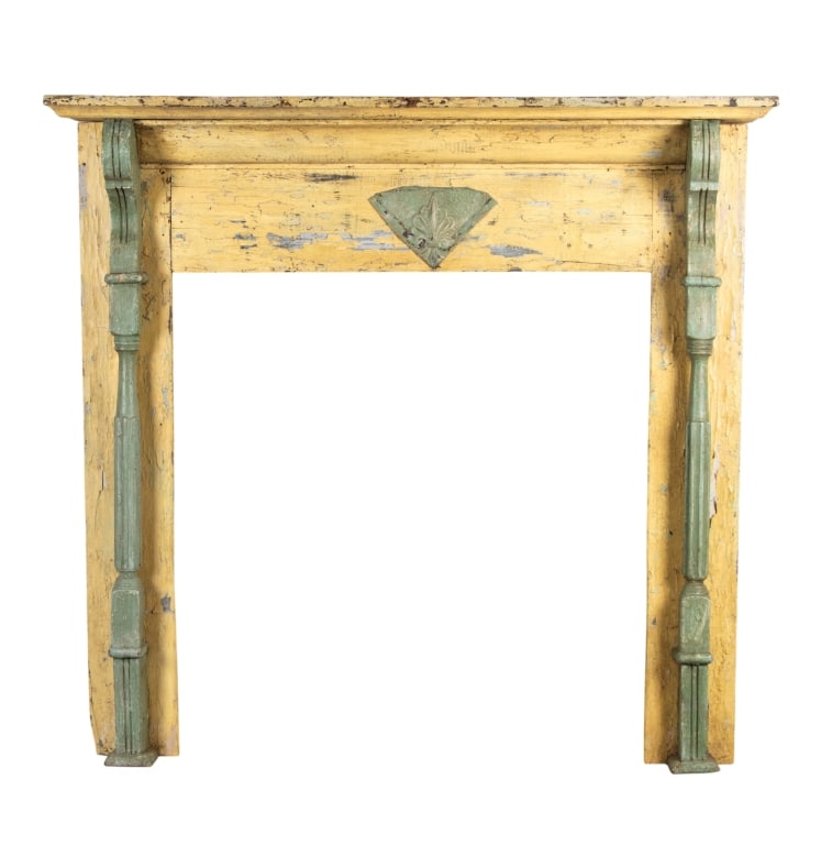 FRENCH PROVINCIAL PAINTED FIREPLACE SURROUND: French provincial fireplace surround painted in green and yellow with carved supports and carved medallion. Approximate dimensions: h. 50", w. 52", d. 8" Disclaimer: Participating bidders must have a