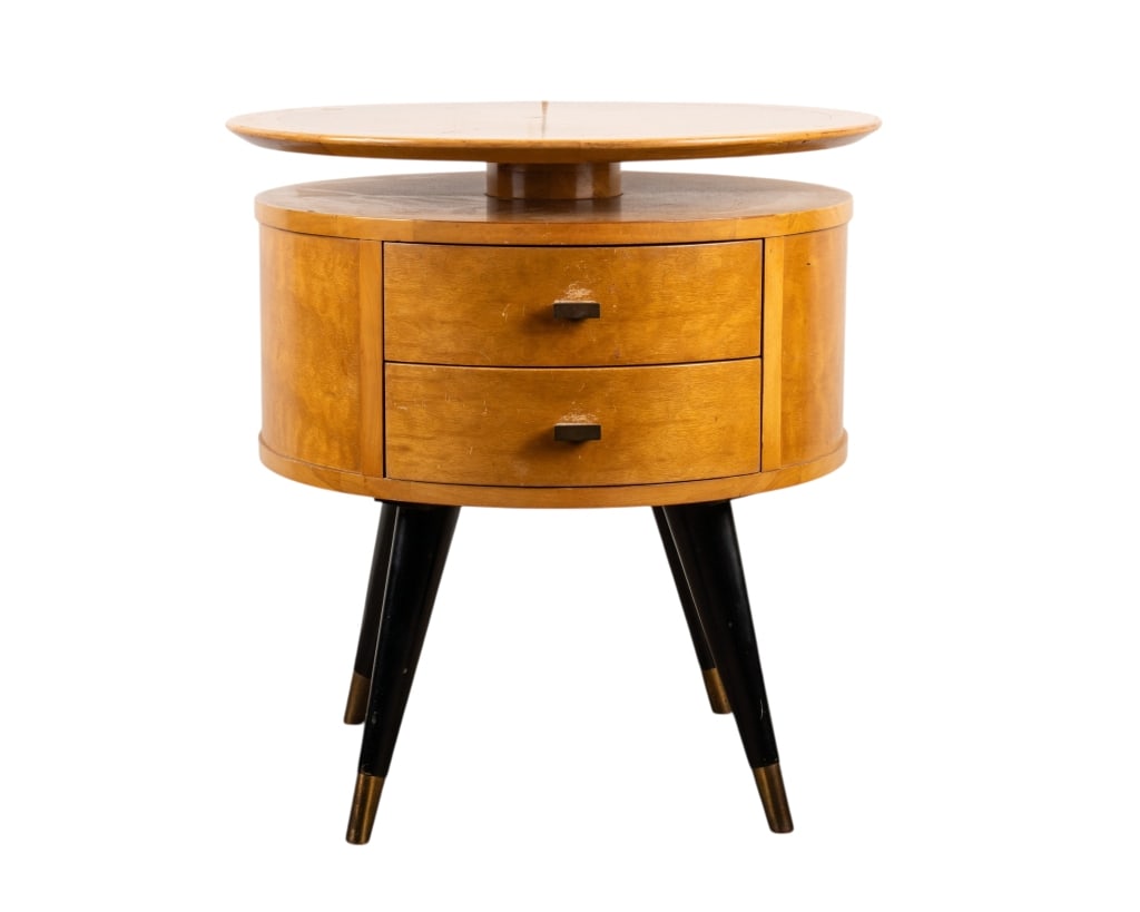 MID-CENTURY WARSAW FURNITURE SIDE TABLE: Mid-century Warsaw Furniture side table with two drawers, brass pulls, brass finish feet, and lift top surface. Approximate dimensions: h. 22.25", w. dia.24" Disclaimer: Participating bidders must