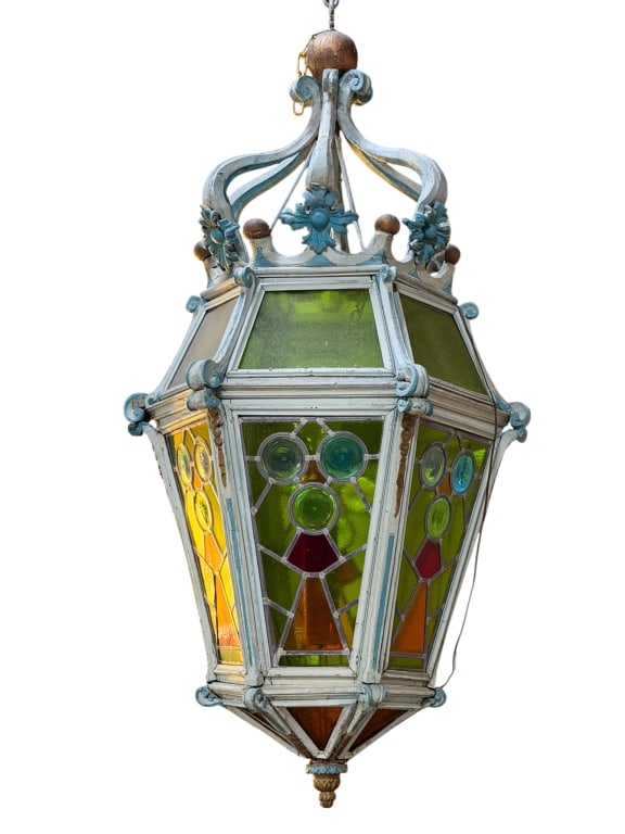 MONUMENTAL STAINED GLASS LANTERN: Monumental stained glass lantern with jeweled accents, carved detail, and floral motif accents. Approximate dimensions: h. 72", w. 40", d. 40" Disclaimer: Participating bidders must have a credit