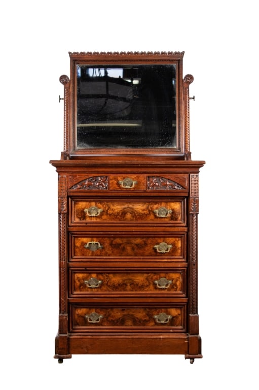 LATE 19TH CENTURY EASTLAKE WALNUT DRESSER: Late 19th century. Eastlake walnut dresser with beveled mirror, carved supports, carved gallery, carved inset panels, and brass pulls. Approximate dimensions: h. 67", w. 34", d. 21" Disclaimer: Partic