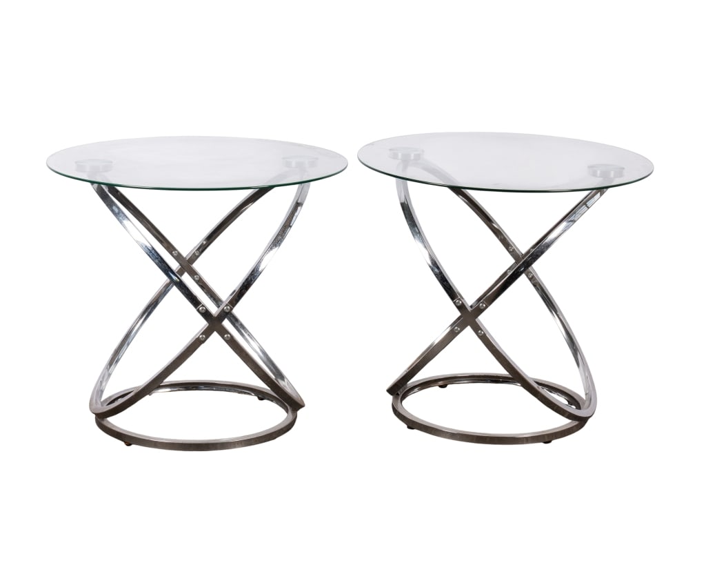 PAIR OF MODERN CHROME & GLASS END TABLES: Pair of modern chrome and glass end tables. Approximate dimensions: h. 24", dia. 26" Disclaimer: Participating bidders must have a credit card on file with LiveAuctioneers in order for their bidding