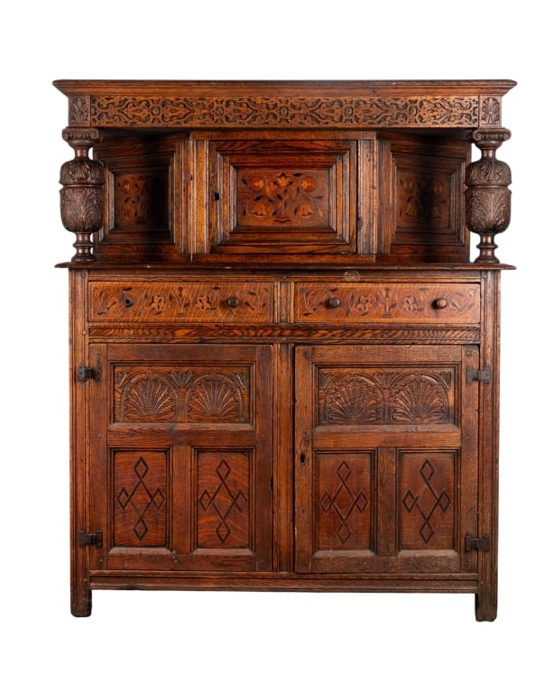 FRENCH RENAISSANCE REVIVAL COURT CUPBOARD: French Renaissance Revival court cupboard with inset carved panels, wood-turned pulls, carved supports, and floral motif carving throughout. Approximate dimensions: h. 60", w. 50", d. 21" Disclaimer: