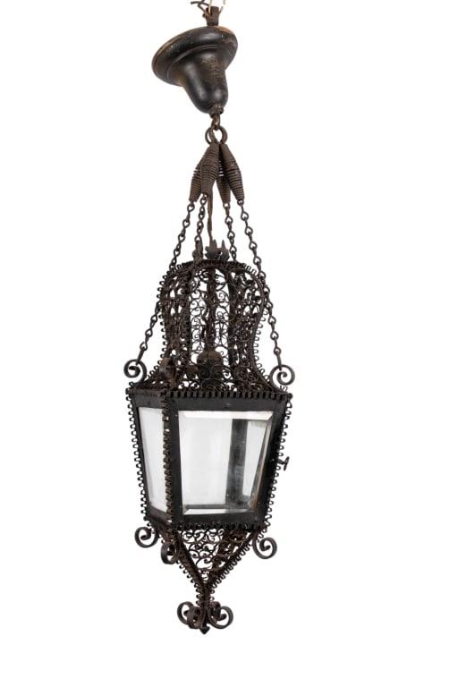 ARTS & CRAFTS IRON FILIGREE PENDANT LANTERN: Arts & Crafts iron filigree pendant lantern with beveled glass and one light. Approximate dimensions: h. 33", w. 8", d. 8" Disclaimer: Participating bidders must have a credit card on file with