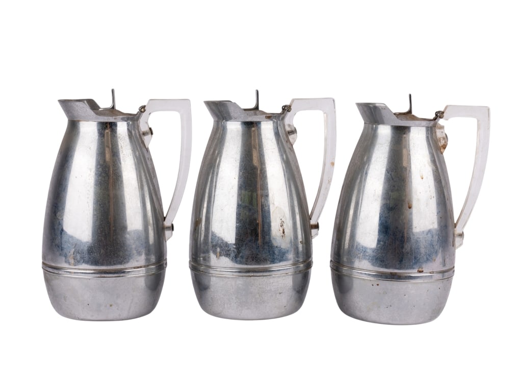 THREE THE AMERICAN THERMOS BOTTLE CO. PITCHERS: Three The American Thermos Bottle Co. pitchers. Marked to the bottom, model 2585, acrylic handles. Approximate dimensions: h. 9.5", w. 7", d. 5.5" Disclaimer: Participating bidders must have a credit