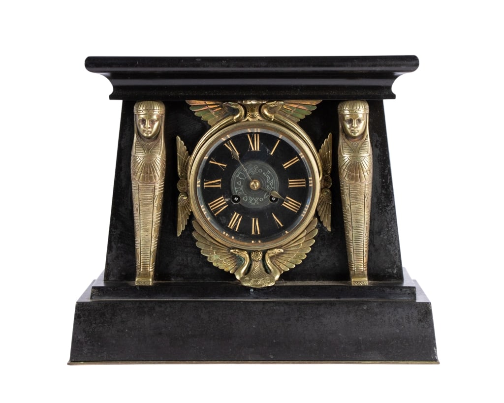 20TH C. EGYPTIAN REVIVAL MANTLE CLOCK: 20th century. Egyptian revival mantle clock with figural mounts. Approximate dimensions: h. 12", w. 16.5", d. 4.5" Disclaimer: Participating bidders must have a credit card on file with LiveAuctioneer