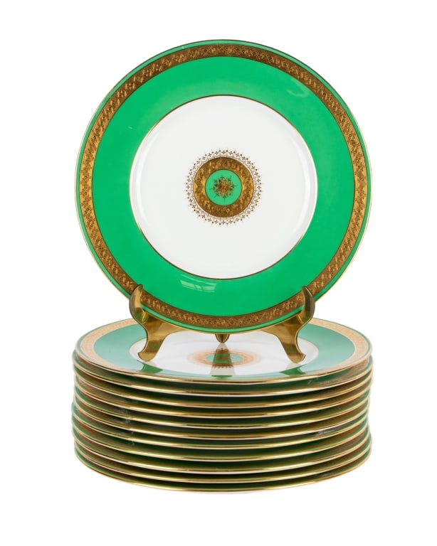 SET OF 12 MINTON PORCELAIN SERVICE PLATES: Set of 12 Minton porcelain service plates, green and gilt. Marked to the underside. Approximate dimensions: dia. 10.25" Disclaimer: Participating bidders must have a credit card on file with