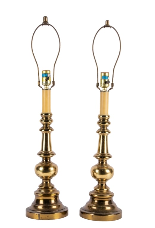 PAIR OF MID-CENTURY BRASS TABLE LAMPS: Pair of Mid-Century brass table lamps. Approximate dimensions: h. 21", dia. 6" Disclaimer: Participating bidders must have a credit card on file with LiveAuctioneers in order for their bidding