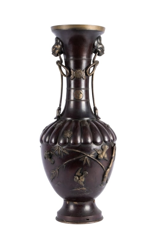 CHINOISERIE FLORAL MOTIF BRONZE VASE: Chinoiserie floral motif bronze vase with floral motif, bird and bamboo accents, and lion head handles with tassel details. Approximate dimensions: h. 26", dia. 12" Disclaimer: Participating bidders
