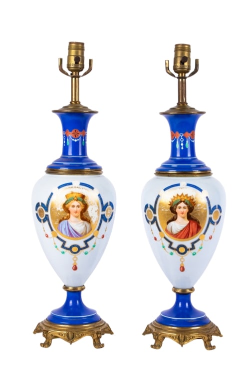 PAIR OF SEVRES STYLE FIGURAL PORCELAIN LAMPS: Pair of Sevres style figural porcelain lamps with brass bases and classical portraits of women in gold circles. Approximate dimensions: h. 23.5", dia. 7" Disclaimer: Participating bidders must have a