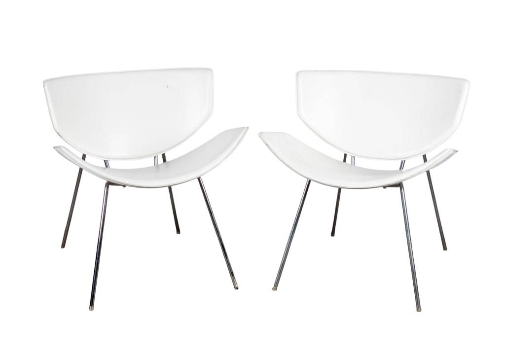 PAIR OF MCM STYLE ACCENT CHAIRS: chrome base, white faux leather seats and backs Approximate dimensions: h. 27", w. 26", d. 17" Disclaimer: Participating bidders must have a credit card on file with LiveAuctioneers in order for